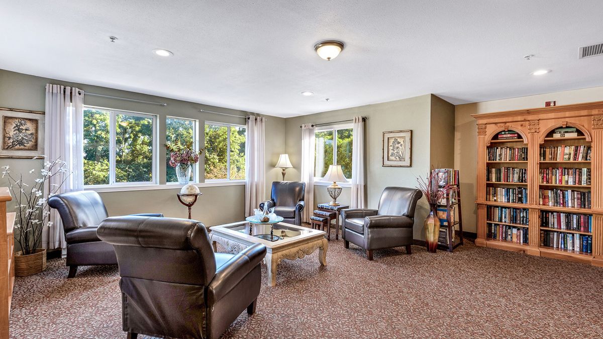 A cozy living room with comfortable seating and large windows.