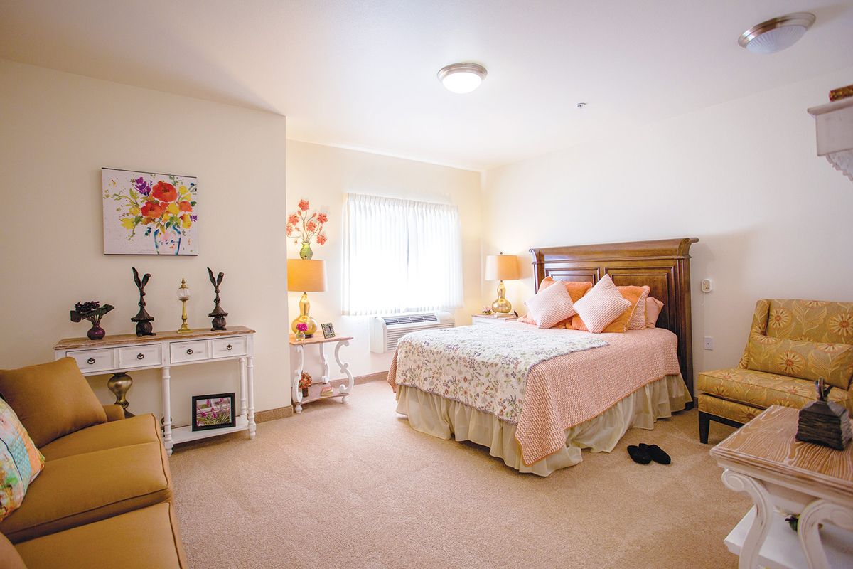 A cozy bedroom with elegant decor and bright lighting.