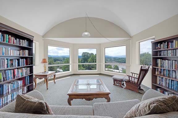A bright living room with large windows offering a scenic view.