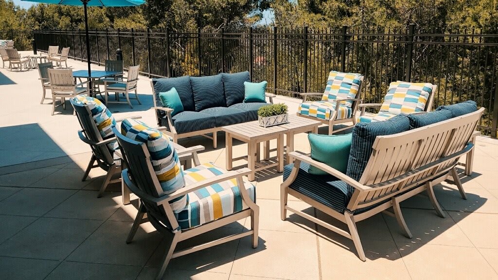 Stylish outdoor patio with comfortable seating and vibrant cushions.