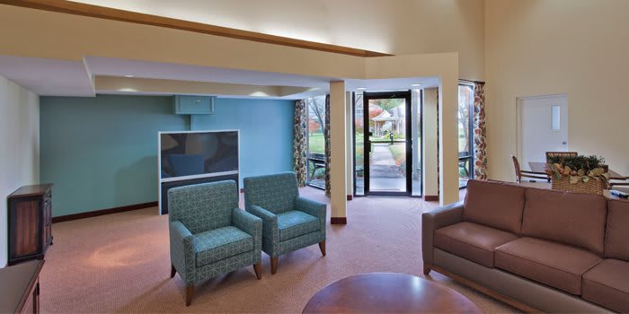 A cozy living room with comfortable seating and a large television.