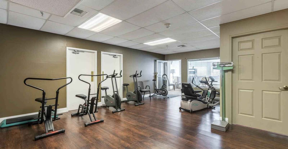 A fitness room equipped with various exercise machines.