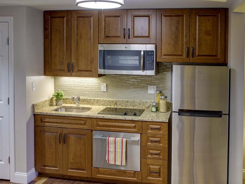 A modern kitchen with wooden cabinets and stainless steel appliances.