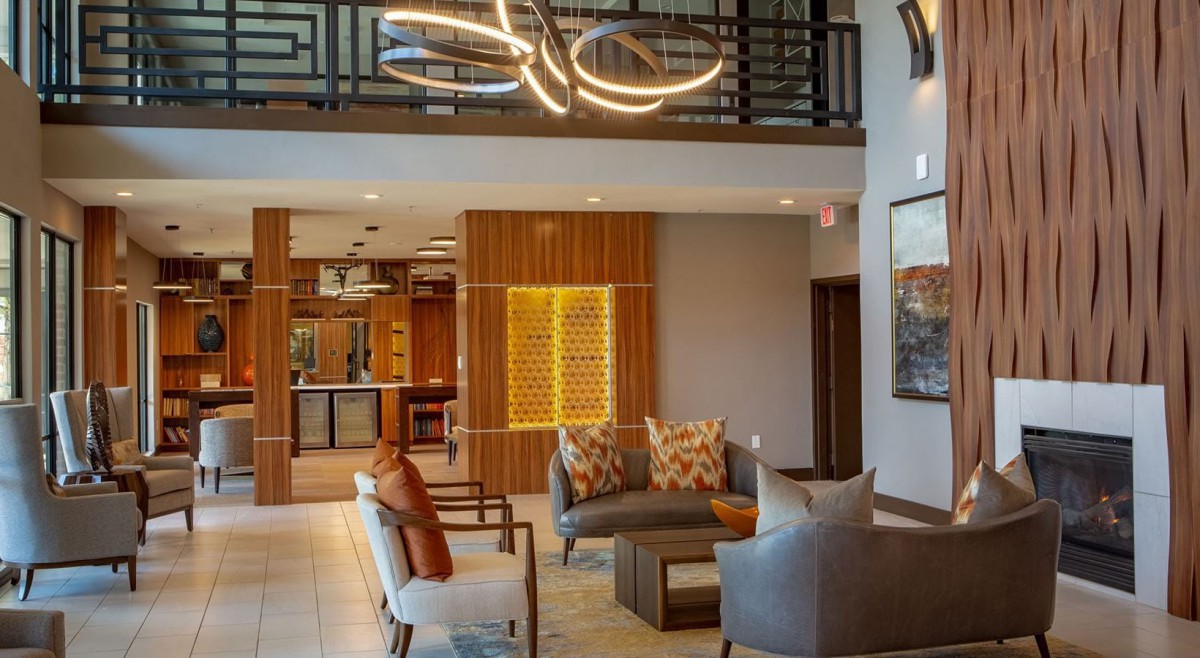 A modern lobby with stylish seating and a unique chandelier.