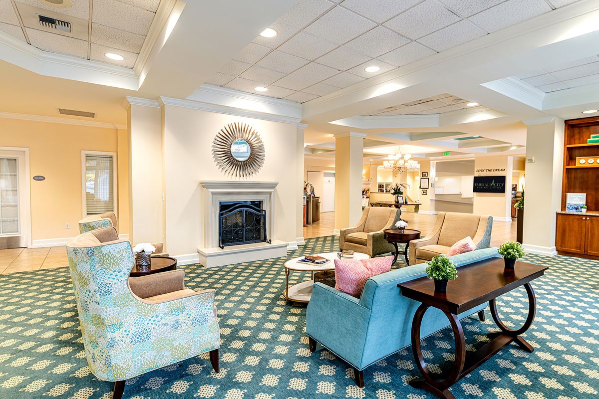 A cozy living room interior with a fireplace and comfortable seating.