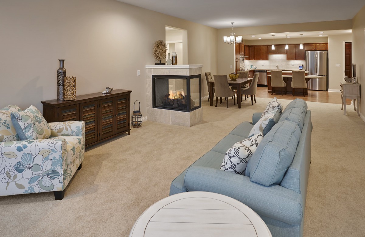 A spacious open-concept living and dining area featuring a cozy fireplace and comfortable seating.
