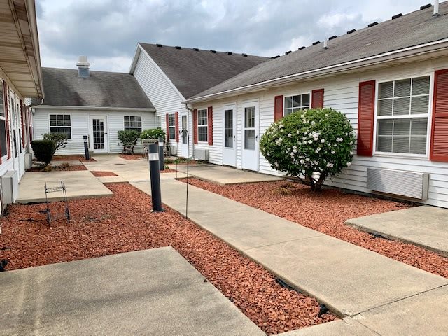A view of a residential housing area with pathways and well-maintained gardens.