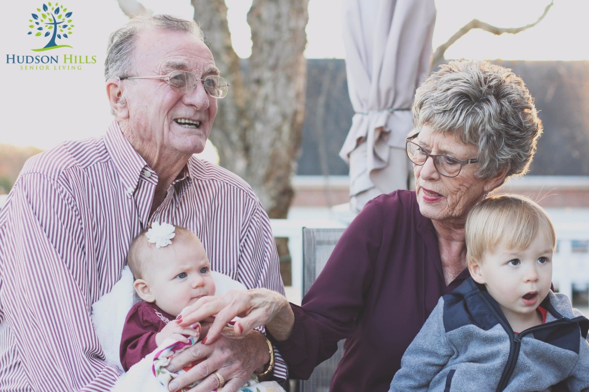 Grandparents enjoying time with their grandchildren outdoors.