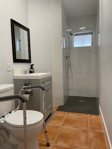 A modern bathroom featuring a glass shower, sleek sink, and minimalistic design.