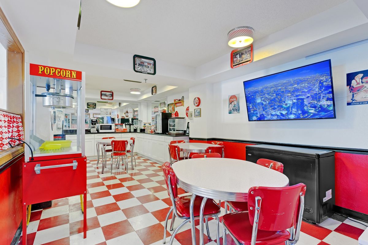 A retro-style diner with red and white checkered floors and vintage decor.