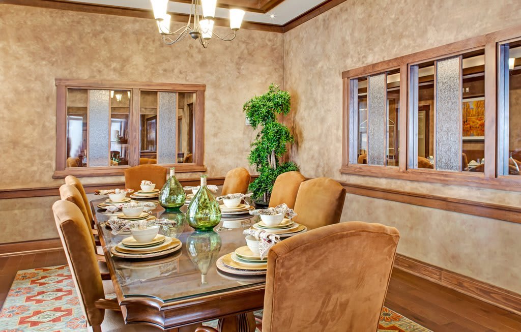 Elegant dining room with a well-set table and warm, inviting decor.