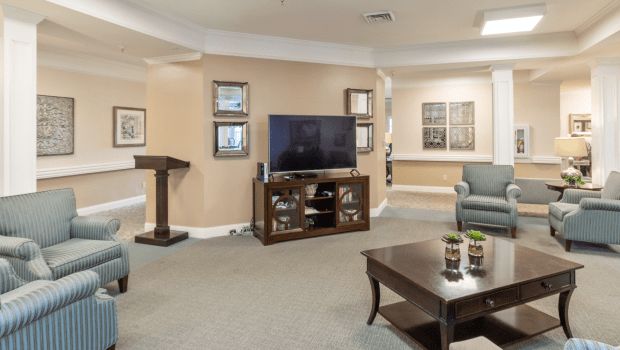 A cozy living room with a television, coffee table, and comfortable seating.