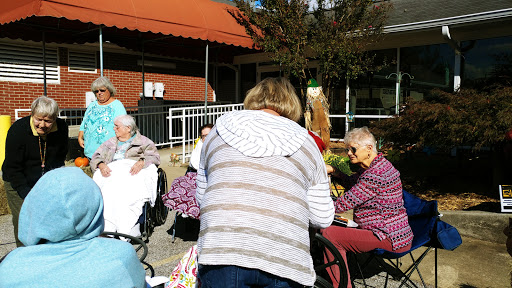 Residents enjoying a sunny day outside their care facility.