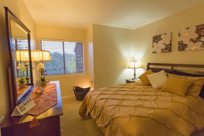 A cozy bedroom with warm lighting and elegant decor.