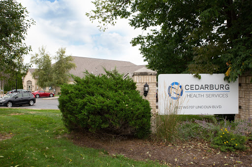 The entrance to Cedar Health, featuring clear signage and a landscaped area.
