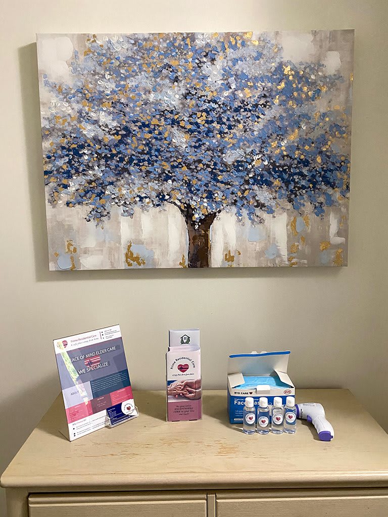 A cozy corner featuring a painting of a tree and assorted health products on display.