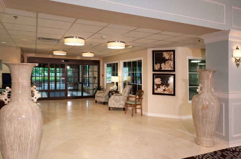 A spacious and elegantly designed lobby with comfortable seating, contemporary lighting, and artwork on the walls.