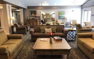 A cozy living room interior with comfortable sofas and a central coffee table.