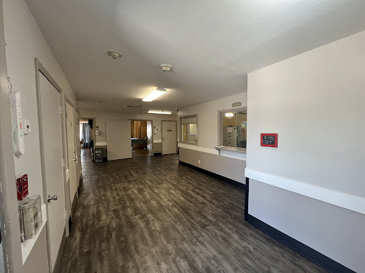 A spacious interior hallway with modern flooring and bright lighting.