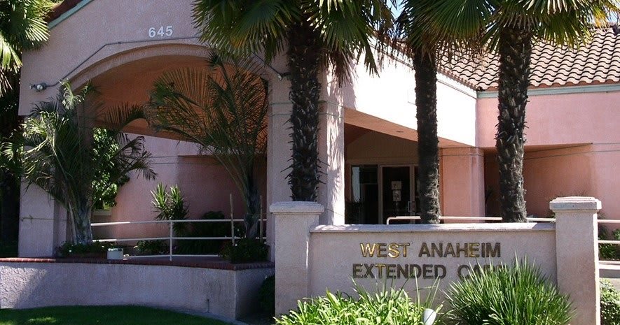 Entrance to the West Anaheim Extended Care facility with palm trees and signage.