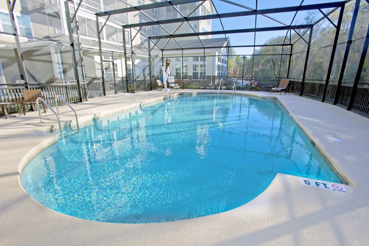 An indoor swimming pool enclosed in a spacious residential setting.