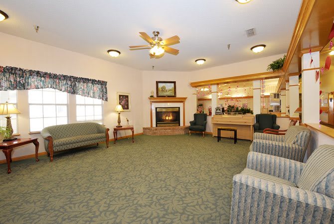 A spacious living room with a fireplace, comfortable seating, and elegant dcor.