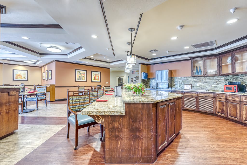 A spacious and modern kitchen with a central island and wood flooring.