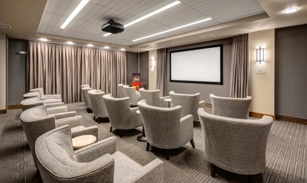 A modern home theater with comfortable seating and a large projection screen.