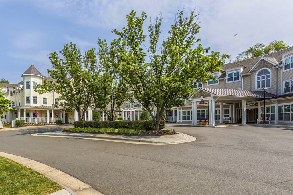 A scenic view of a building surrounded by trees and a clear sky.