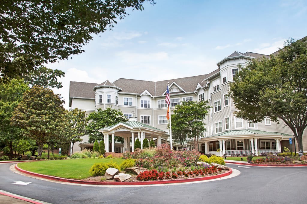 A beautiful residential building with a landscaped garden and entrance.