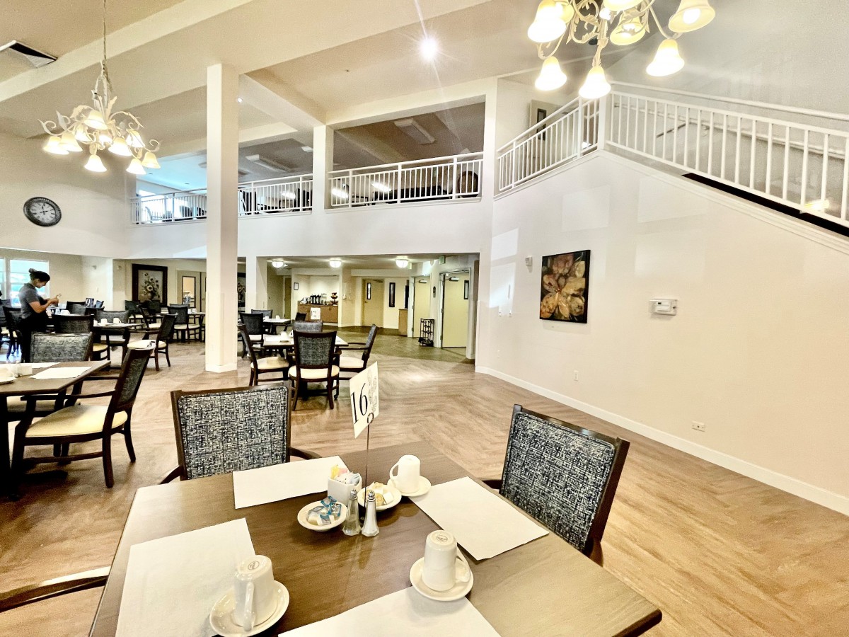 A spacious and elegantly decorated dining area with neatly arranged tables and chairs.