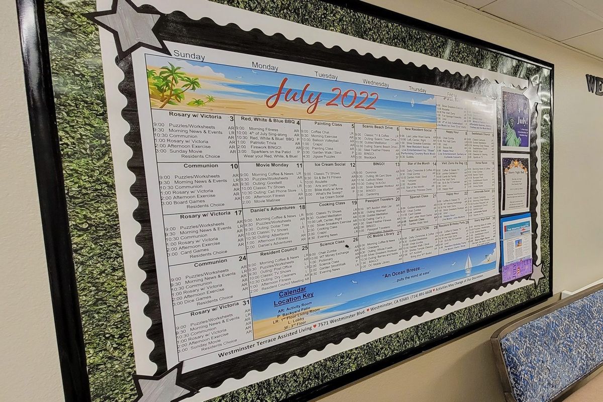 A bulletin board featuring a July 2023 calendar with a beach theme.