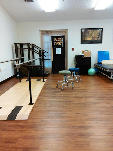 A view of a therapy room equipped for rehabilitation exercises.