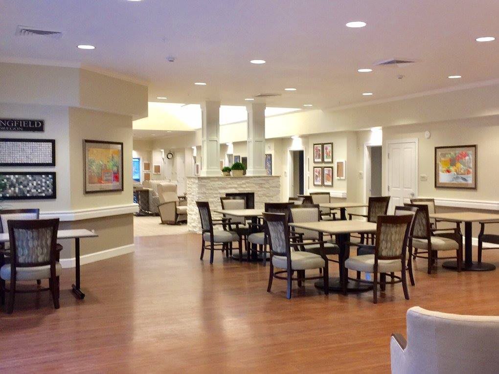 A spacious dining area with tables and chairs, well-lit with modern decor.