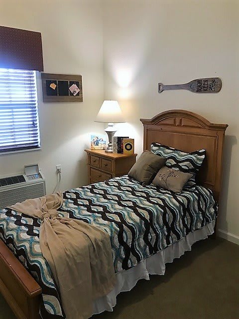 Cozy bedroom with a single bed and wooden furniture.
