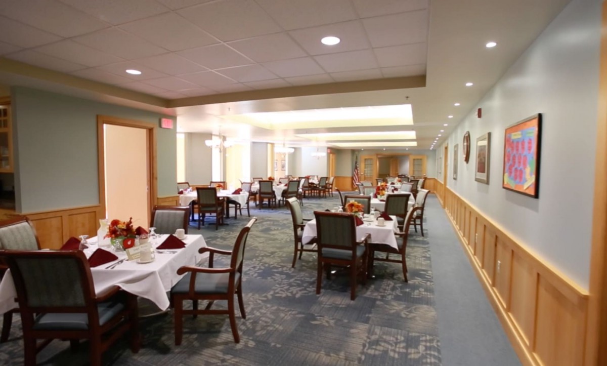 A spacious dining room with neatly arranged tables and chairs, featuring elegant interior decor.
