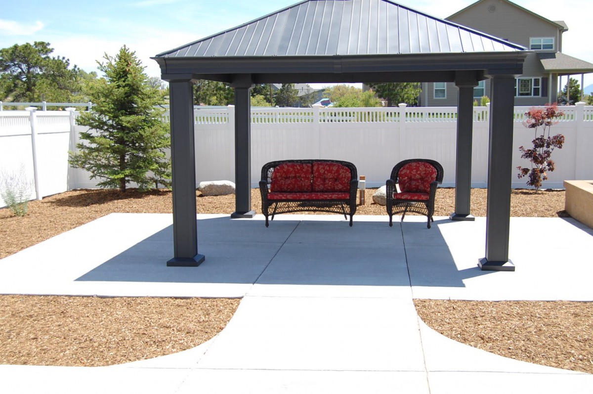 A patio with a gazebo and outdoor seating.