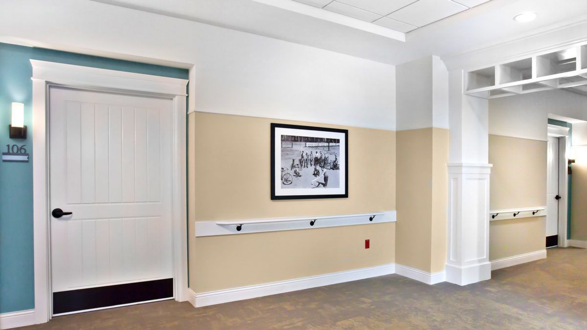 A hallway interior with a framed black and white photograph on the wall.