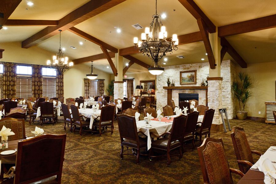 A cozy restaurant dining area with elegant chandeliers and neatly arranged tables.