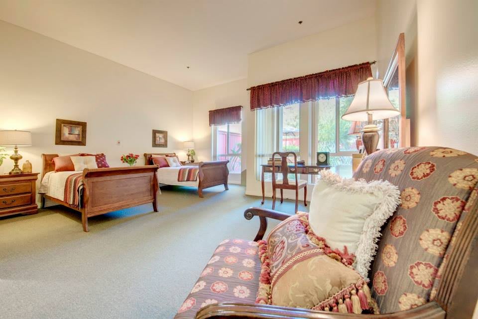 A cozy living room with elegant furniture and large windows letting in natural light.
