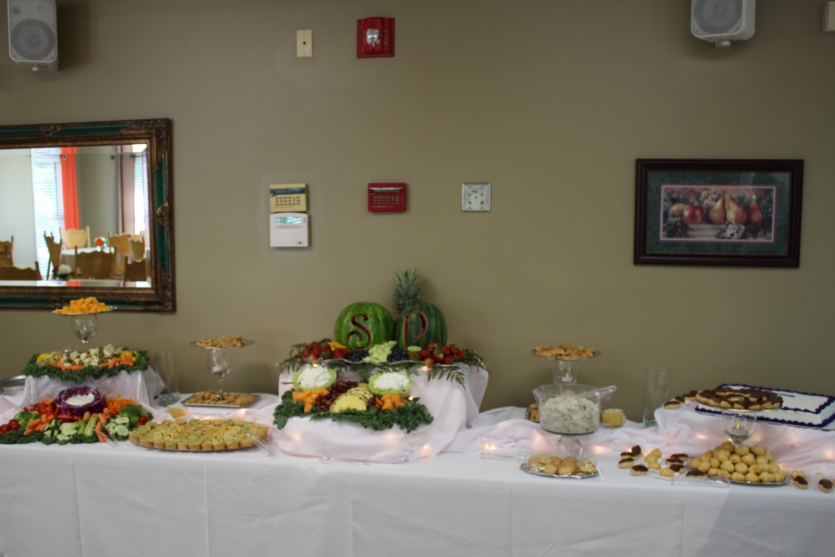 A buffet table set up with a decorative display of food for an event.