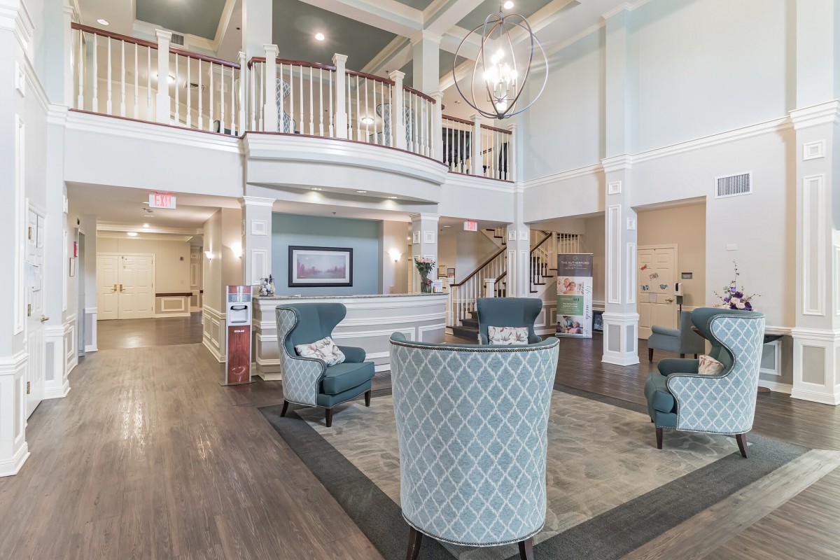 A spacious lobby with elegant furniture and lighting.