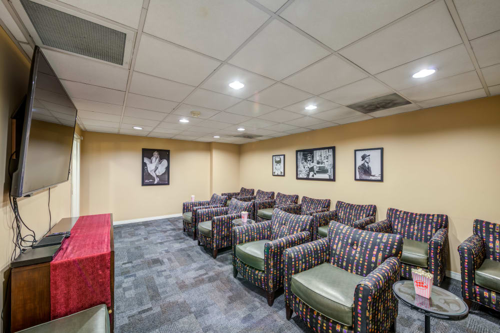 A small meeting room with arranged chairs and framed artwork on the walls.