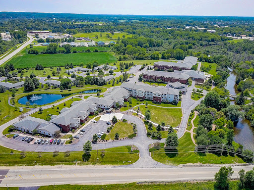 A peaceful aerial view of a well-maintained residential complex surrounded by lush greenery.