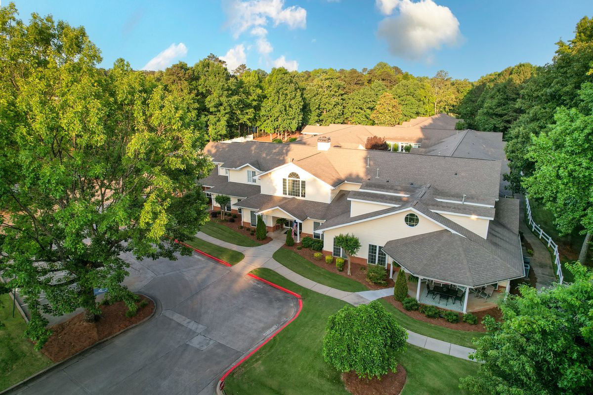 Aerial view of a residential building surrounded by trees.