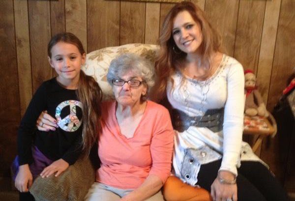 Three generations of a family smiling together.