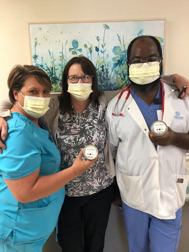 Healthcare professionals proudly showing their commitment to patient care.