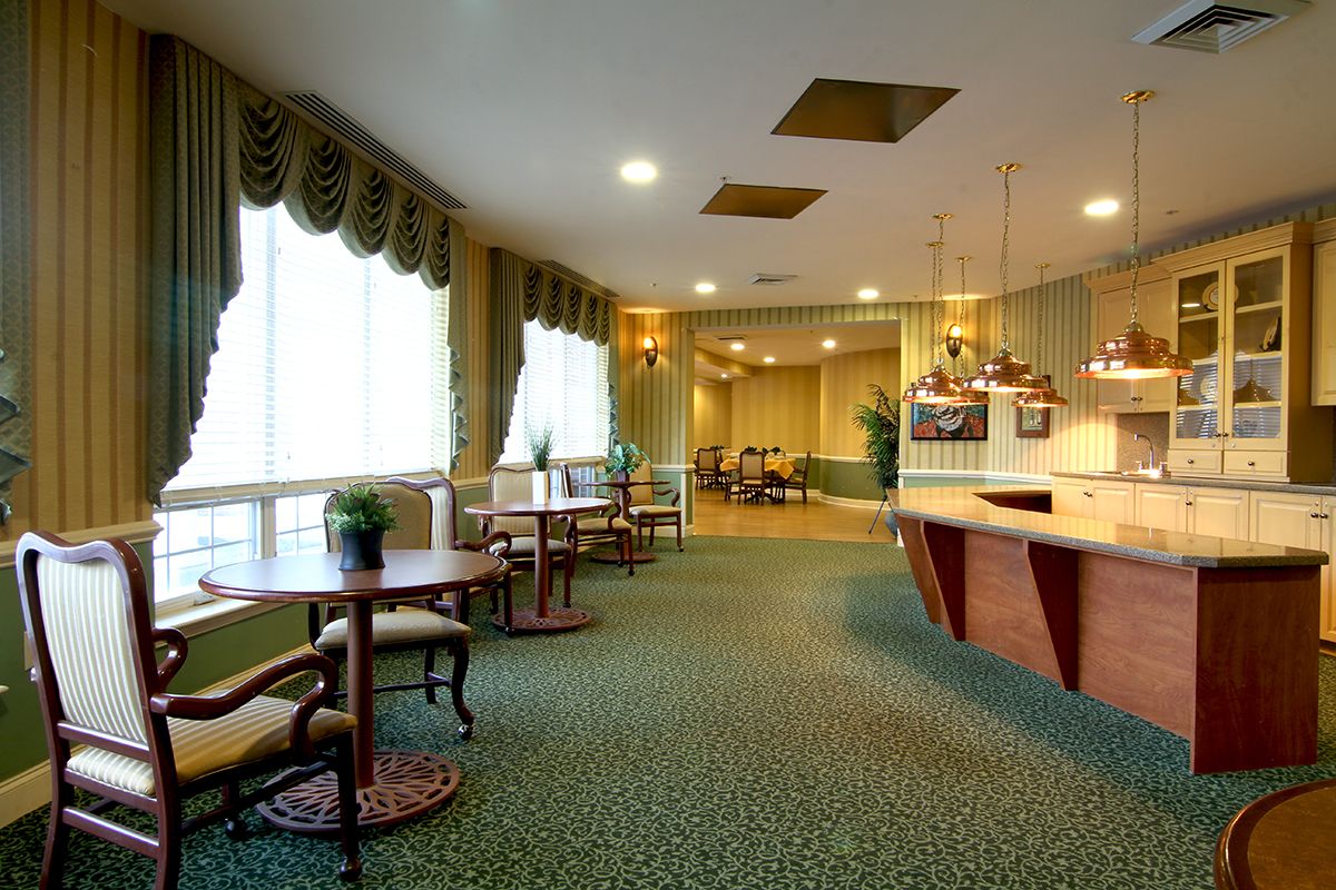 A spacious lobby with elegant furniture and subdued lighting.