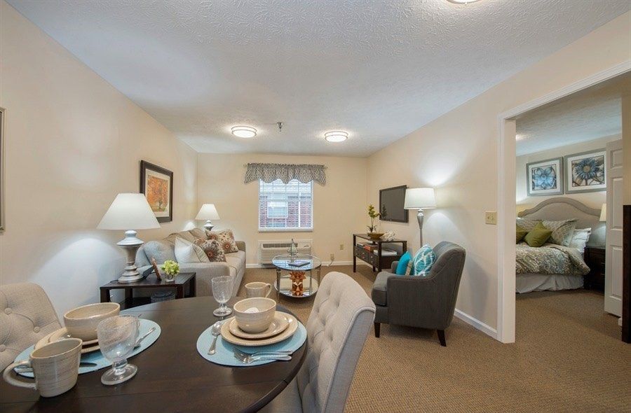 A cozy living and dining area with elegant table settings and warm lighting.