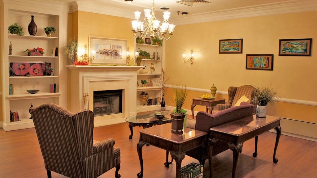 A cozy, traditionally designed living room with a fireplace and elegant furniture.